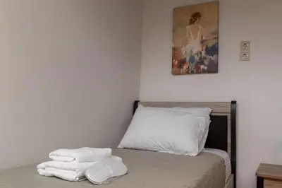 a bedroom with a bed with towels on it at Ariadne de Potie Maisonette in Chania Town