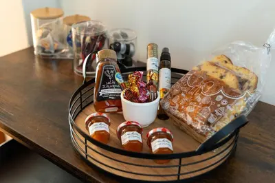 a basket with bottles of beer and bread on a table at Ariadne de Potie Maisonette in Chania Town