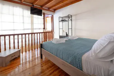 a bedroom with a bed and a balcony at Ariadne de Potie Maisonette in Chania Town