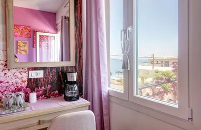 a room with a window and a table with a blender at Elpida's Gοds in Chania Town