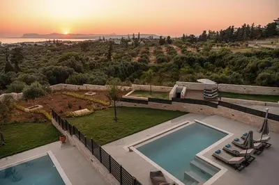 an aerial view of a house with two swimming pools at Kymélia Luxury Residences With Sea View in Galatás