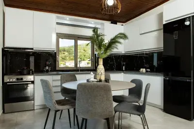 a kitchen with a table and some chairs and a table at Cozy House Zoi -Top Views, On The Way To Elafonisi in Élos