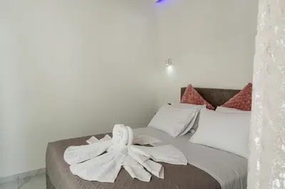 a bedroom with a bed with a flower on it at Cozy House Zoi -Top Views, On The Way To Elafonisi in Élos