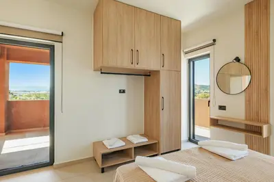 a bedroom with two beds and a mirror and a window at Madre Tierra Boutique Villas 1 & 2 in Liyidhés