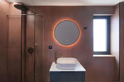 a bathroom with a sink and a shower with a mirror at Madre Tierra Boutique Villas 1 & 2 in Liyidhés