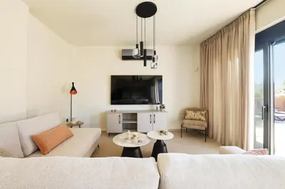 a living room with a couch and a table at Madre Tierra Boutique Villas 1 & 2 in Liyidhés