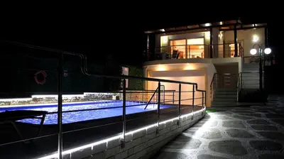 a house with a swimming pool at night at Villa Sofia Filoxenia in Kalyves
