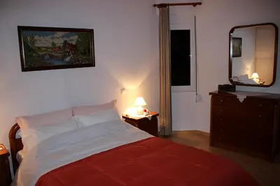 a bedroom with a bed with a mirror and a dresser at Villa Sofia Filoxenia in Kalyves