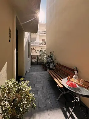 a hallway with a table and a bench at Spiti an urban heaven in Chania Town