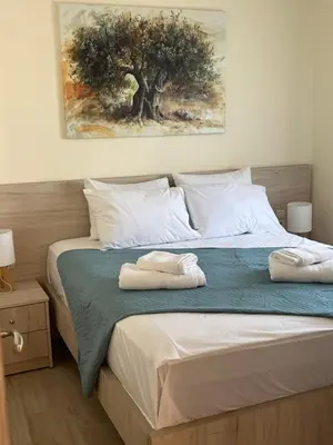 a bedroom with a bed with two towels on it at Two little olives Studio apartment in Kissamos