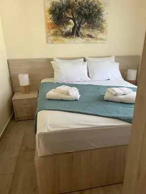 a bedroom with a bed with two pillows on it at Two little olives Studio apartment in Kissamos