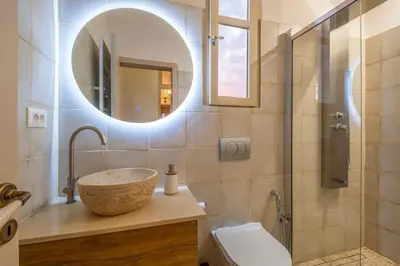 a bathroom with a sink and a mirror at Le Nid The Nest of Beauty in Chania Town