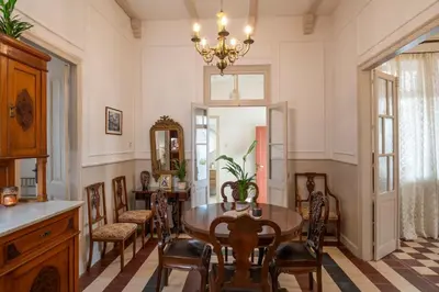 a dining room with a table and chairs and a chandelier at Le Nid The Nest of Beauty in Chania Town