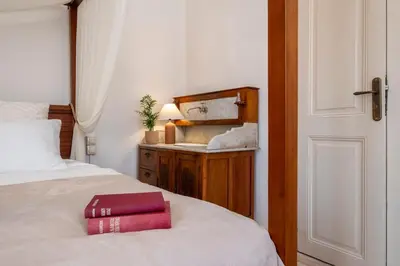 a bedroom with a bed with a red box on it at Le Nid The Nest of Beauty in Chania Town