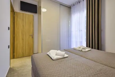 a bedroom with a bed with two towels on it at Jimmis Apartment in Chania Town