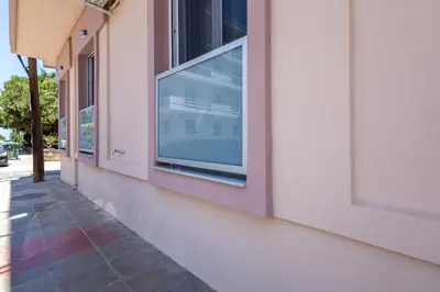 a window on the side of a pink building at Jimmis Apartment in Chania Town