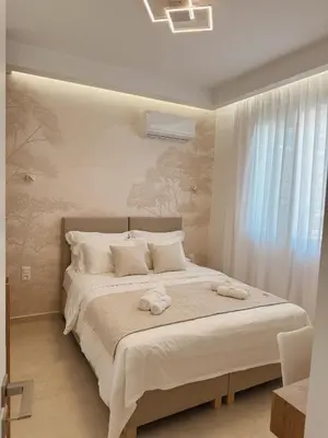 a bedroom with a large bed with towels on it at Dida stone home in Chania Town