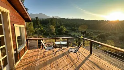 a deck with a table and chairs on a house at The Root House - Crete Stay in Vafés