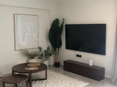 a living room with a flat screen tv on a wall at Casa del Sol - Kalathas in Kalathas