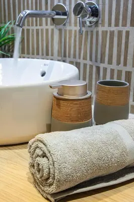 a bathroom with a sink and a towel on a counter at Seatherial Apartments Paleochora in Palaiochóra