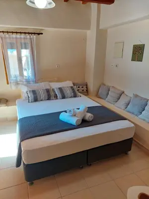 a bedroom with a bed with a teddy bear on it at Casa Cretese Chania in Tsikalariá