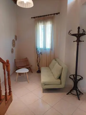 a living room with a couch and a table at Casa Cretese Chania in Tsikalariá
