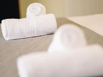 a roll of toilet paper sitting on top of a bed at Chania Charming Nest in Chania Town