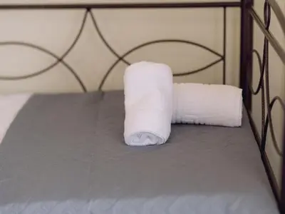 a roll of toilet paper sitting on top of a bed at Chania Charming Nest in Chania Town
