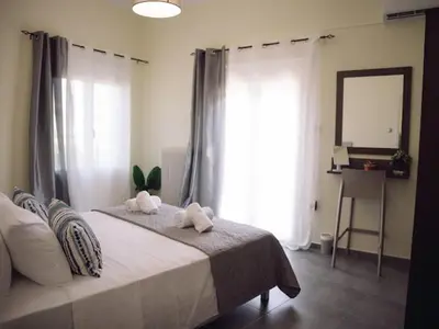a bedroom with a bed with two towels on it at Chania Charming Nest in Chania Town