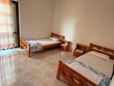 a bedroom with two beds and a window at Retro Groove in Palaiochóra