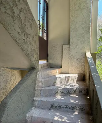 a set of stairs leading up to a house at Retro Groove in Palaiochóra