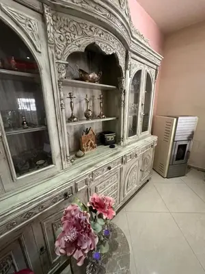 a large wooden hutch with a vase of flowers at Casa Emanuel in Chania Town