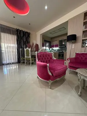 a living room with a pink couch and a table at Casa Emanuel in Chania Town