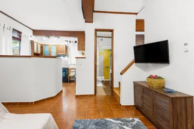 a living room with a flat screen tv on a wall at Spitatsi - Home with Yard in Chania Town