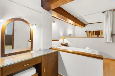 a bathroom with a sink and a mirror at Spitatsi - Home with Yard in Chania Town
