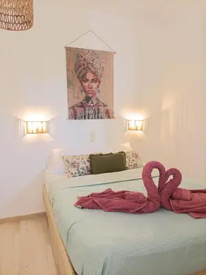 a bedroom with two beds with red towels on them at Menta Apartment's in Maleme