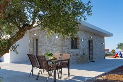 a table and chairs in front of a house at ''Filoxenia'' of the 11 Brothers in Kissamos
