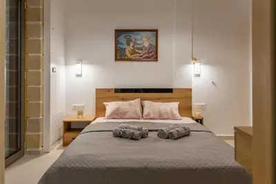 a bedroom with a bed with two towels on it at ''Filoxenia'' of the 11 Brothers in Kissamos