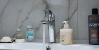 a bathroom counter with bottles of soap and a sink at ''Filoxenia'' of the 11 Brothers in Kissamos