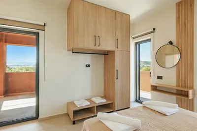 a bedroom with two beds and a mirror and a window at Madre Tierra Boutique Villa 3 in Potistíria