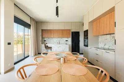 a kitchen with a wooden table and chairs at Madre Tierra Boutique Villa 3 in Potistíria