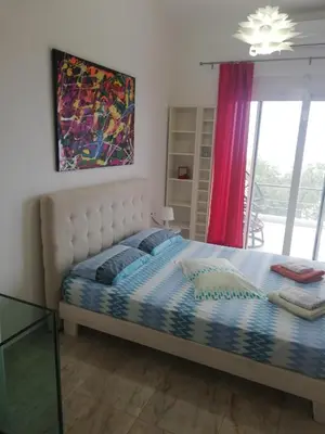a bedroom with a bed with a painting on the wall at Andreas Villa in Kato Daratso
