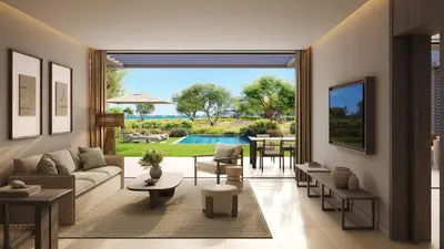 a living room with a couch and tables and a pool at Ikos Kissamos in Kissamos