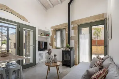 a living room with a couch and a table at Villa Manmar 2BR with Sleeping Lofts by etouri in Spiliá