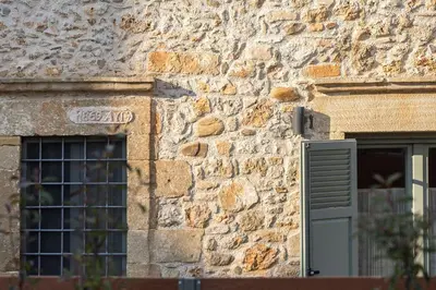 a stone building with a window and a door at Villa Manmar 2BR with Sleeping Lofts by etouri in Spiliá