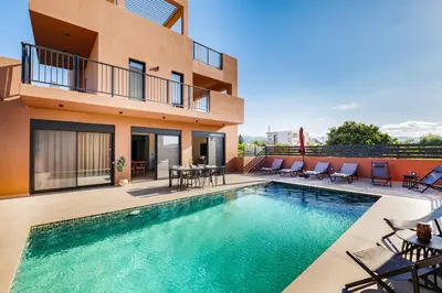 a swimming pool in front of a house at Madre Tierra Boutique Villa 4 in Potistíria