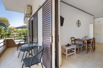 a balcony with chairs and a table and a table and chairs at Seafront Apartment in Chania 6 in Chania Town
