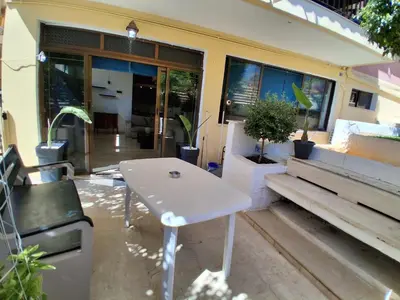 a white table and bench in front of a building at Diotima apartment in Chania Town