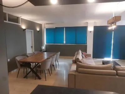 a living room with a table and a couch at Diotima apartment in Chania Town