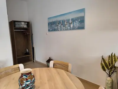 a dining room table with a vase on top of it at Despoinas House in Plátanos